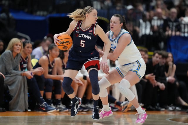 Apr 4, 2025; Tampa, FL, USA;  Connecticut Huskies guard Paige Bueckers (5) dribbles against UCLA Bruins forward Angela Dugalic (32)  during the third quarter in a semifinal of the women's 2025 NCAA tournament at Amalie Arena. Mandatory Credit: Kirby Lee-Imagn Images/File Photo