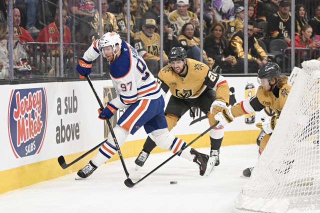 Connor McDavid #97 of the Edmonton Oilers makes a pass against William Karlsson #71 and Brett Howden #21 of the Vegas Golden Knights in the first period of Game One of the Second Round of the 2025 Stanley Cup Playoffs at T-Mobile Arena on May 06, 2025 in Las Vegas, Nevada. The Oilers defeated the Golden Knights 4-2.