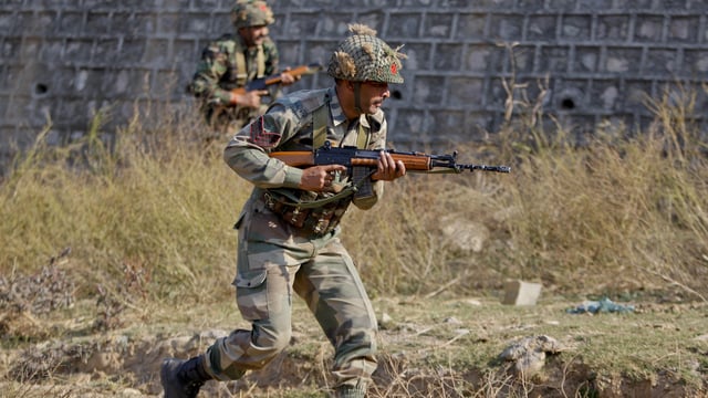 Indian army soldiers during a search operation in a forest area outside the Pathankot air force base in Pathankot.