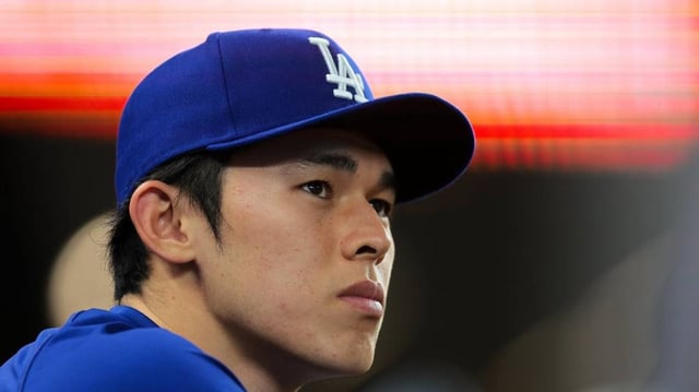 May 5, 2025; Miami, Florida, USA; Los Angeles Dodgers starting pitcher Roki Sasaki (11) looks on from the dugout against the Miami Marlins during the ninth inning at loanDepot Park. Mandatory Credit: Sam Navarro-Imagn Images