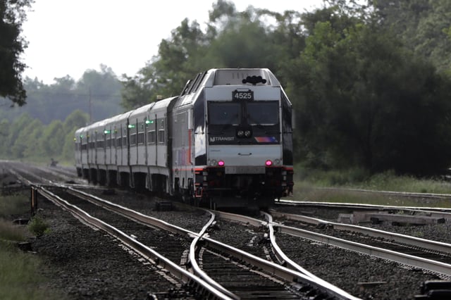FILE - In this Aug. 3, 2018, file photo, a New Jersey Transit train leaves the Bound Brook Station in Bound Brook, N.J. (AP Photo/Julio Cortez, File)