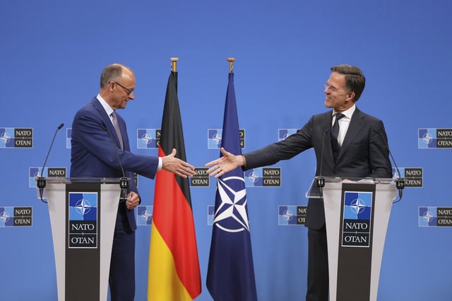 Germany's Chancellor Friedrich Merz, left, shakes hands with NATO Secretary General Mark Rutte during a media conferenc6 at NATO headquarters in Brussels, Friday, May 9, 2025. (AP Photo/Virginia Mayo)