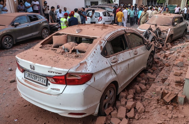 Damaged vehicles after Pakistani artillery shelling in Jammu