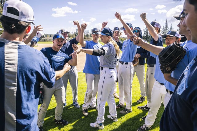 Marika Lyszczyk, a sophomore pitcher on the Sonoma State University baseball team, center, leads players in a cheer after practice in Rohnert Park in 2023. A court has ruled that the school can proceed with eliminating its Division II athletics program, as well as six academic departments. 