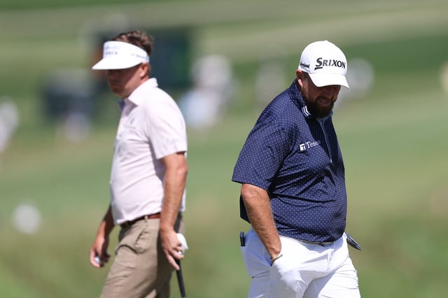 May 10, 2025; Philadelphia, Pennsylvania, USA; Shane Lowry (R) and Keith Mitchell (L) prepare to putt on the fourth hole during the third round of the Truist Championship golf tournament. Mandatory Credit: Bill Streicher-Imagn Images