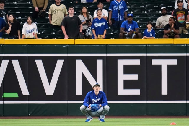Dodgers pitcher Roki Sasaki, of Japan, watches batting practice prior to a baseball game against the Arizona Diamondbacks Thursday, May 8, 2025, in Phoenix. (AP Photo/Ross D. Franklin)