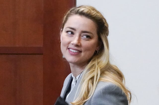 FILE - Actor Amber Heard leaves during a break in the courtroom at the Fairfax County Circuit Courthouse in Fairfax, Va., May 27, 2022. (AP Photo/Steve Helber, Pool, file)
