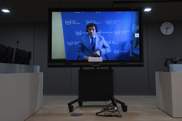 FILE - Former Philippine President Rodrigo Duterte is seen on a screen in the courtroom of the International Criminal Court (ICC) in The Hague, Netherlands, March 14, 2025. (AP Photo/Peter Dejong, Pool, file)