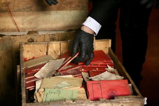 A person holds Nazi-related material that was originally confiscated by local authorities when it was shipped to Argentina in 1941, after several boxes containing the material were recently discovered by chance in the archives of the Supreme Court of Argentina, in Buenos Aires, Argentina in this handout picture released on May 11, 2025. Corte Suprema de Justicia de la Republica Argentina/Handout via REUTERS