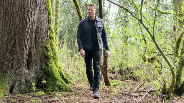 Colter walking through the woods in Tracker