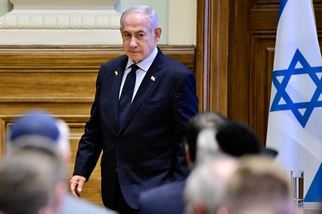 Israeli Prime Minister Benjamin Netanyahu walks as he visits Ludovika University of Public Service in Budapest, Hungary, April 4, 2025. REUTERS/Marton Monus