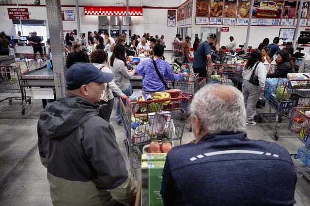 Shoppers line up to check out at a Costco Wholesale. A listeria outbreak hospitalized at least 10 individuals in California and Nevada, prompting a voluntary recall of over 80 ready-to-eat products by Fresh &amp; Ready Foods.  