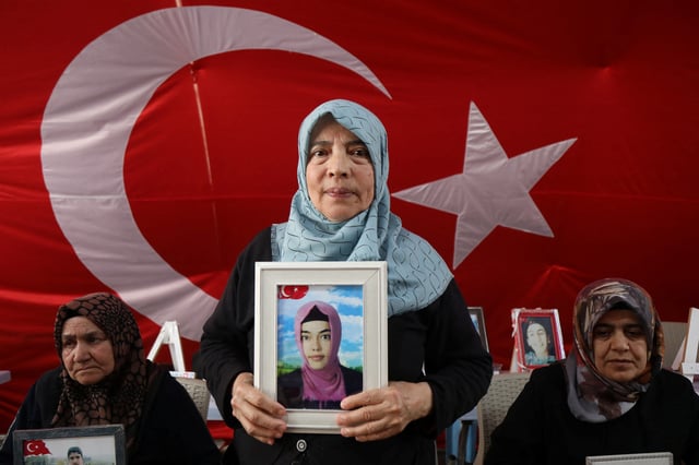Hatice Levent holds a picture of her daughter Fadime who is believed to have joined the outlawed Kurdistan Workers' Party (PKK) as families of young people who they say were recruited by the PKK gather outside the local office of the pro-Kurdish DEM Party, as PKK disbands and ends 40-year Turkey insurgency, in the southeastern city of Diyarbakir, Turkey, May 12, 2025. REUTERS/Sertac Kayar