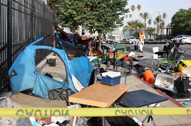 City sanitation workers clear an encampment as workers help bring unhoused people to interim housing, as part of an &#39;Inside Safe&#39; operation, on September 26, 2024 in Los Angeles, California.