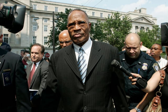 FILE - In this Tuesday, July 29, 2008 file photo, former Newark Mayor Sharpe James, center, leaves the U.S. District Court in Newark, N.J., after he was sentenced to more than two years in federal prison for his role in the cut-rate sales of city land to his former mistress. James, 77, was robbed Thursday, April 11, 2013, put in a chokehold and stripped of a gold chain and cross. He was not injured. (AP Photo/Mike Derer, File)
