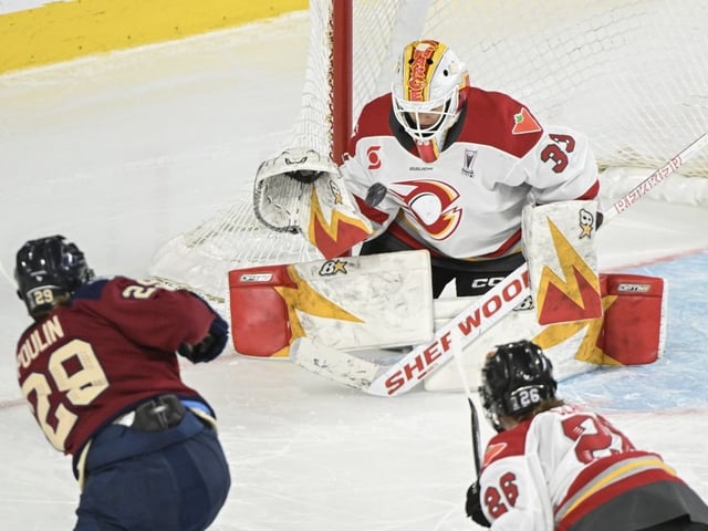 Montreal Victoire's Marie-Philip Poulin (29) takes a shot on Ottawa Charge goaltender Gwyneth Philips (33) as Charge's Emily Clark (26) defends.
