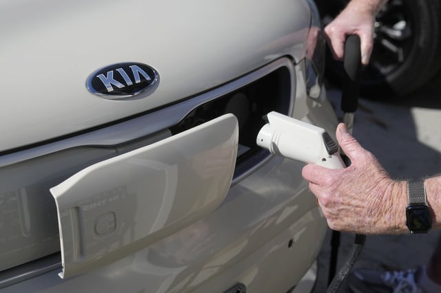FILE - Ken Honeycutt demonstrates charging his Kia Soul electric vehicle in San Lorenzo, Calif., Nov. 9, 2024. (AP Photo/Jeff Chiu, File)