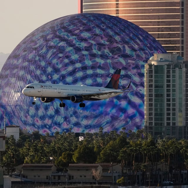 Delta Air Lines flight lands at Harry Reid International Airport, Wednesday, April 9, 2025, in Las Vegas. (AP Photo/John Locher)