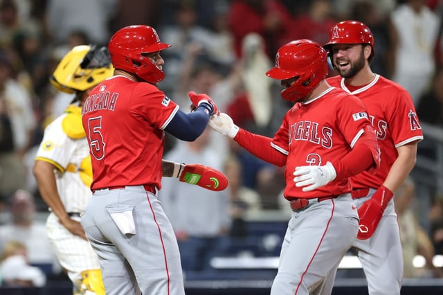The Angels’ Yoán Moncada, left, and Nolan Schanuel, far right, congratulate Taylor Ward after he hit a tiebreaking grand slam in the ninth inning of their game against the San Diego Padres on Monday night in San Diego. The Angels scored six runs in the ninth on just two hits to win, 9-5. (Photo by Sean M. Haffey/Getty Images)