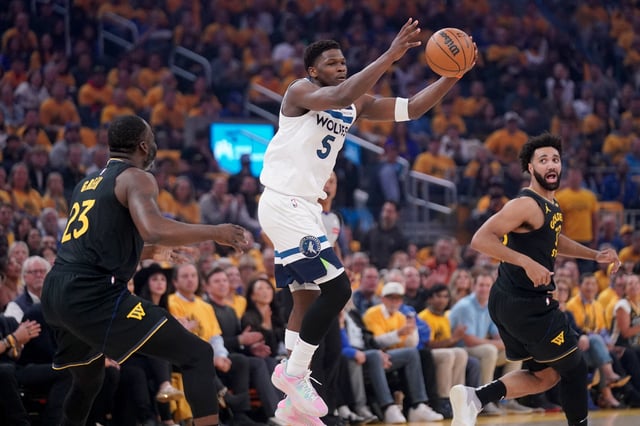 May 12, 2025; San Francisco, California, USA; Minnesota Timberwolves guard Anthony Edwards (5) holds onto the ball in front of Golden State Warriors forward Draymond Green (23) in the first quarter during game four of the second round for the 2025 NBA Playoffs at Chase Center. Mandatory Credit: Cary Edmondson-Imagn Images