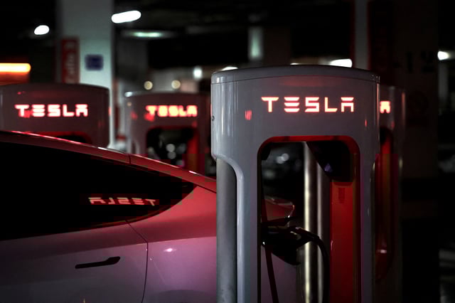 A Tesla electric vehicle is charged at a Tesla Supercharger battery charging station in Barakaldo, Spain, March 29, 2025. REUTERS/Vincent West/File Photo