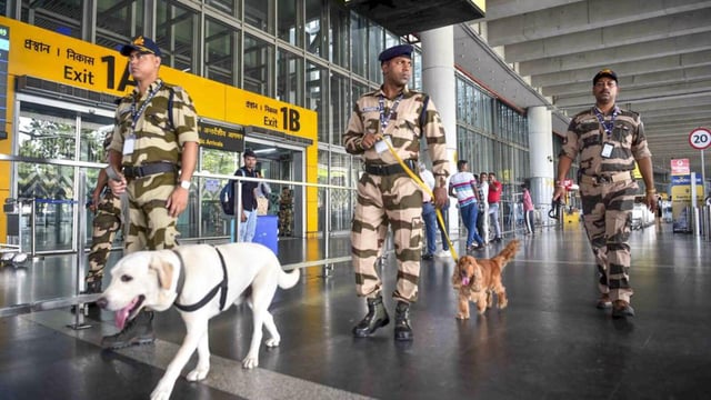 CISF personnel with sniffer dogs keep a vigil at the Netaji Subhas Chandra Bose International Airport in Kolkata. (PTI Photo)
