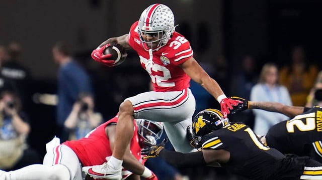 Dec 29, 2023; Arlington, Texas, USA; Ohio State Buckeyes running back TreVeyon Henderson (32) carries the ball against Missouri Tigers defensive back Jaylon Carlies (1) in the first quarter during the Goodyear Cotton Bowl Classic at AT&T Stadium.