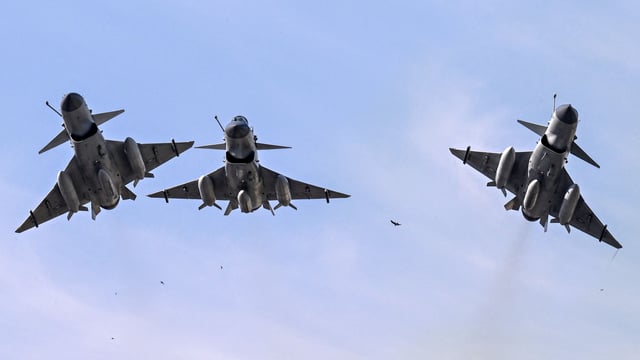 Pakistan Air Force J-10 fighter jets fly past over the President's House during the national day parade in Islamabad on March 23, 2025. (Photo by Aamir QURESHI / AFP)