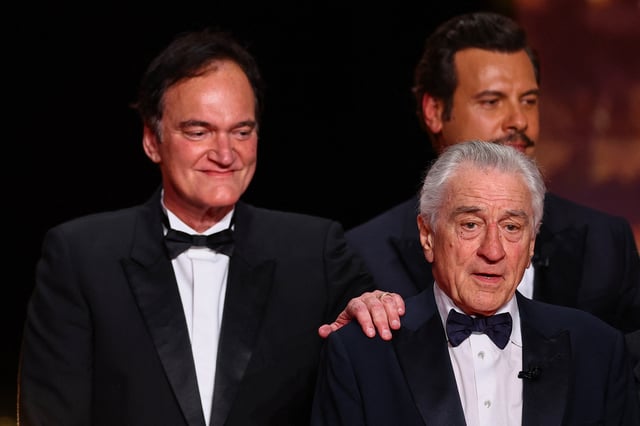 Quentin Tarantino, Robert De Niro and Master of Ceremony Laurent Lafitte pose on stage at the end of the opening ceremony, before the screening  pose on stage at the end of the opening ceremony, and before the screening the film "Partir un jour" (Leave One Day) Out of competition at the 78th Cannes Film Festival in Cannes, France, May 13, 2025. REUTERS/Sarah Meyssonnier