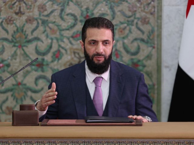 DAMASCUS, SYRIA - MARCH 13: Syrian President Ahmed al-Sharaa signs a declaration outlining the main provisions of the interim constitution in a ceremony held at the People's Palace in the capital Damascus, Syria on March 13, 2025. (Photo by Izettin Kasim/Anadolu via Getty Images)