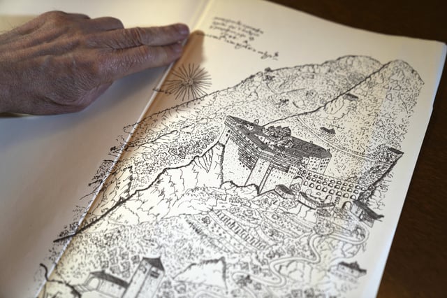 Father Makarios shows a 1744 map depicting the Simonopetra, or the Simonos Petra Monastery, home of the all-male autonomous community Agion Oros, or Holy Mountain, on the peninsula of Mount Athos in northern Greece, Monday, April 14, 2025. (AP Photo/Thanassis Stavrakis)