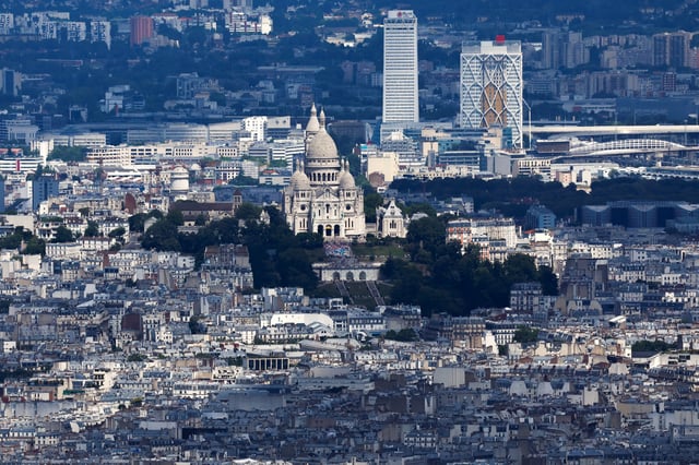 An aerial view shows the Sacre-Coeur Basilica and the Butte Montmartre with the city rooftops of residential apartment buildings ahead of the Paris 2024 Olympics and Paralympics Games near Paris, France, July 10, 2024. REUTERS/Gonzalo Fuentes/File Photo