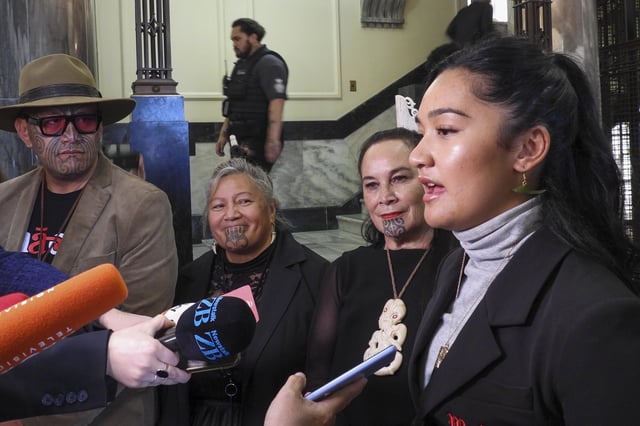 FILE -Hana-Rawhiti Maipi-Clarke, right, and her colleagues from Te Pāti Māori, talk to reporters following a protest inside Parliament in Wellington, New Zealand, Thursday, Nov. 14, 2024. (AP Photo/Charlotte Graham-McLay, File)