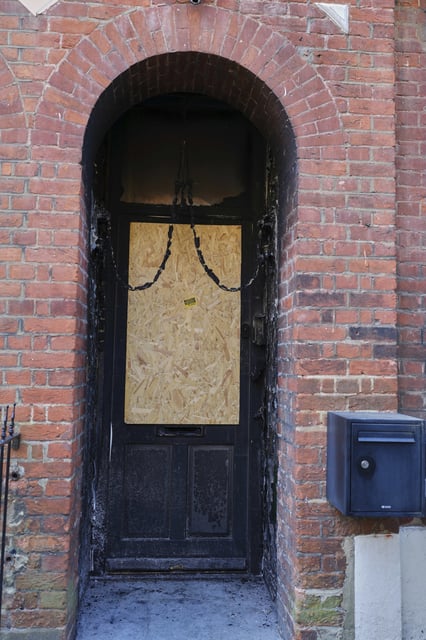 Fire damage is seen in the doorway of a house belonging to British Prime Minister Keir Starmer in Kentish Town in London, Tuesday, May 13, 2025. (AP Photo/Kirsty Wigglesworth)