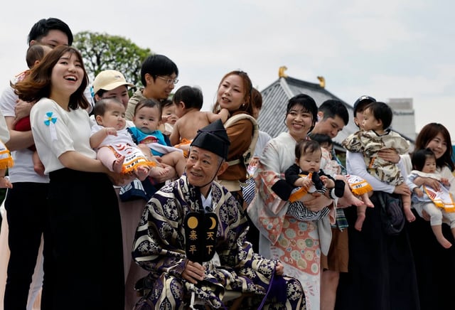 Parents hold their babies before participating in a baby crying contest in Tokyo. Photo: EPA-EFE