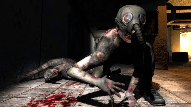 A snork bears his teeth at the camera in a dark room.