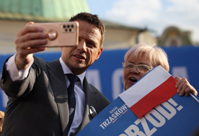 Civic Coalition presidential candidate, Warsaw Mayor Rafal Trzaskowski takes a selfie with his supporter during an election rally in Krakow, Poland, May 13, 2025. REUTERS/Kacper Pempel