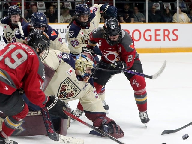  Montreal Victoire goalie Ann-Renee Desbiens eyes the puck in a scramble in front of her net with Ottawa Charge Captain Brianne Jenner (19) close by.