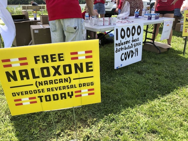 FILE - Signs are displayed at a tent during a health event on June 26, 2021, in Charleston, W.Va. (AP Photo/John Raby, File)