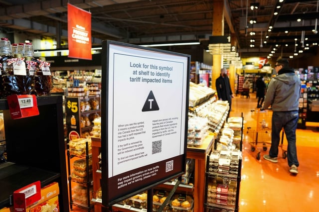 A sign advising that products from the U.S. affected by a tariff will be marked with a symbol at the shelf, with a QR code linking to a Government of Canada website, is seen in a grocery store in Ottawa, on Wednesday, April 2, 2025. THE CANADIAN PRESS/Justin Tang