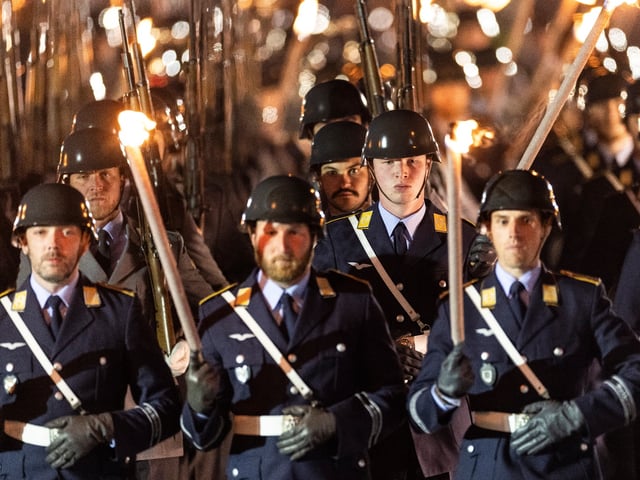 BERLIN, GERMANY - MAY 05: Soldiers from the guard battalion stand with torches during tattoo ceremony for outgoing German Chancellor Olaf Scholz hosted by the Bundeswehr in honour of his service on May 05, 2025 in Berlin, Germany. The Bundestag is scheduled to elect Friedrich Merz of the Christian Democrats (CDU) and confirm his new government tomorrow. (Photo by Maja Hitij/Getty Images)