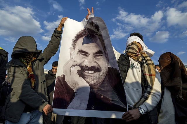 Youngsters hold a photograph of Abdullah Öcalan, the jailed leader of the militant Kurdistan Workers’ Party, or PKK, in Diyarbakır, Turkey, Feb. 27, 2025. Mr. Öcalan issued a call that month for the PKK to lay down its arms.