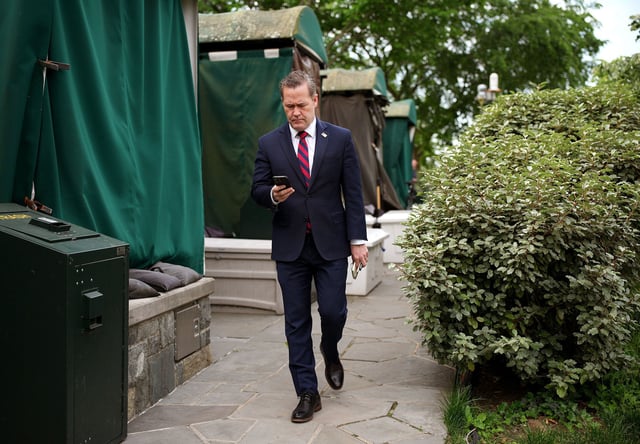 National security adviser Mike Waltz looks at his phone as he prepares for a TV interview at the White House on May 1, in Washington, DC.