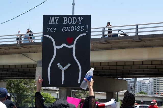 People watch from a bridge as protestors march and chant in Downtown Atlanta, in opposition to Georgia&#39;s new abortion law on July 23, 2022 in Atlanta, Georgia.