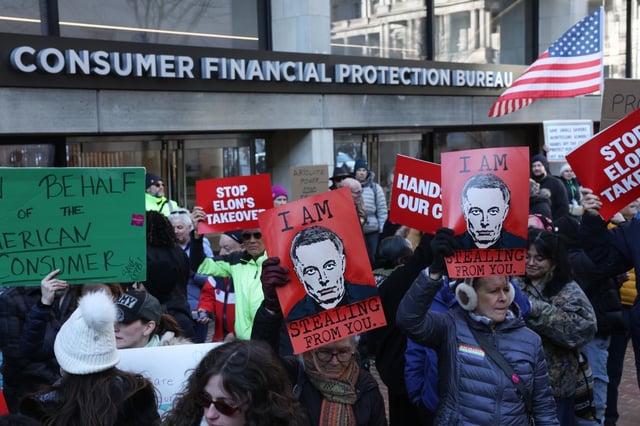 Demonstrators raise signs and posters outside Consumer Financial Protection Bureau headquarters on Feb. 10, 2025 in Washington, D.C. (Photo by Jemal Countess/Getty Images for MoveOn)