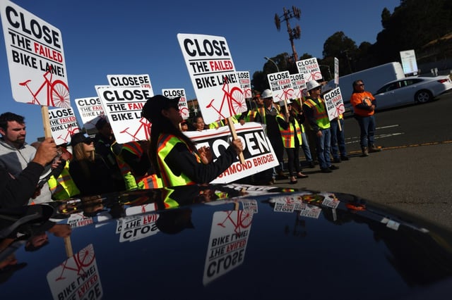 Demonstrators call for action to reopen the third westbound lane on the Richmond-San Rafael Bridge during a rally at the toll plaza in Richmond on Wednesday, May 14, 2025. (Aric Crabb/Bay Area News Group)