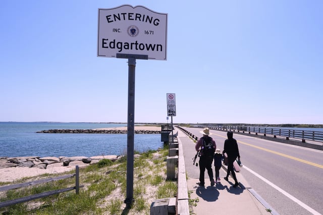 A family walks to the span of the American Legion Memorial Bridge, also known as the "Jaws Bridge", while spending the day fishing, Monday, May 12, 2025, in Edgartown, Mass., on Martha's Vineyard Island. (AP Photo/Charles Krupa)