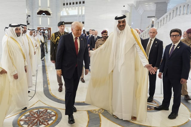 Qatar's Emir Sheikh Tamim bin Hamad Al Thani welcomes President Donald Trump during an official welcoming ceremony at the Amiri Diwan in Doha, Qatar, Wednesday, May 14, 2025. (AP Photo/Alex Brandon)
