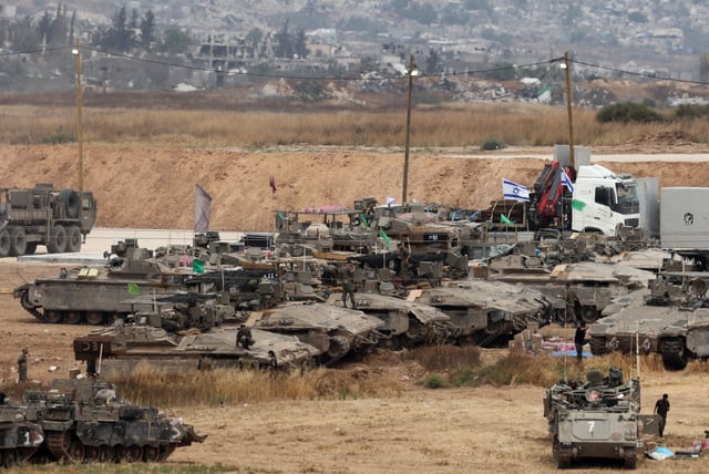 Israeli troops deploy on Israel&#39;s border with the Gaza Strip (background) amid the ongoing war between Israel and the Palestinian militant movement Hamas on May 15, 2025.
