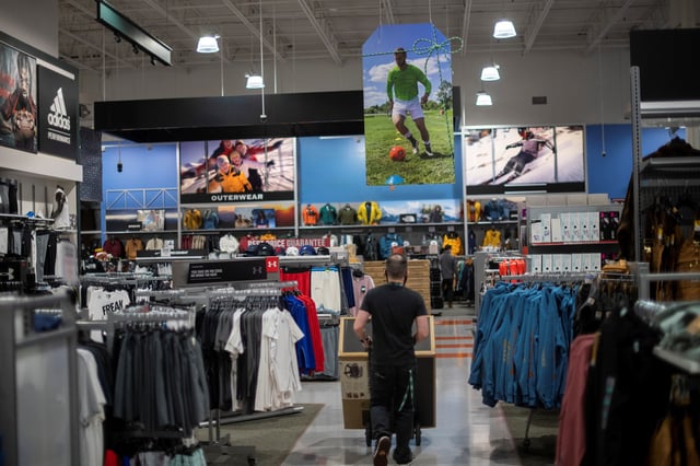 An employee wheels merchandise through a Dick's Sporting Goods store in Collegeville, Pennsylvania U.S. November 20, 2020. REUTERS/Mark Makela/File photo